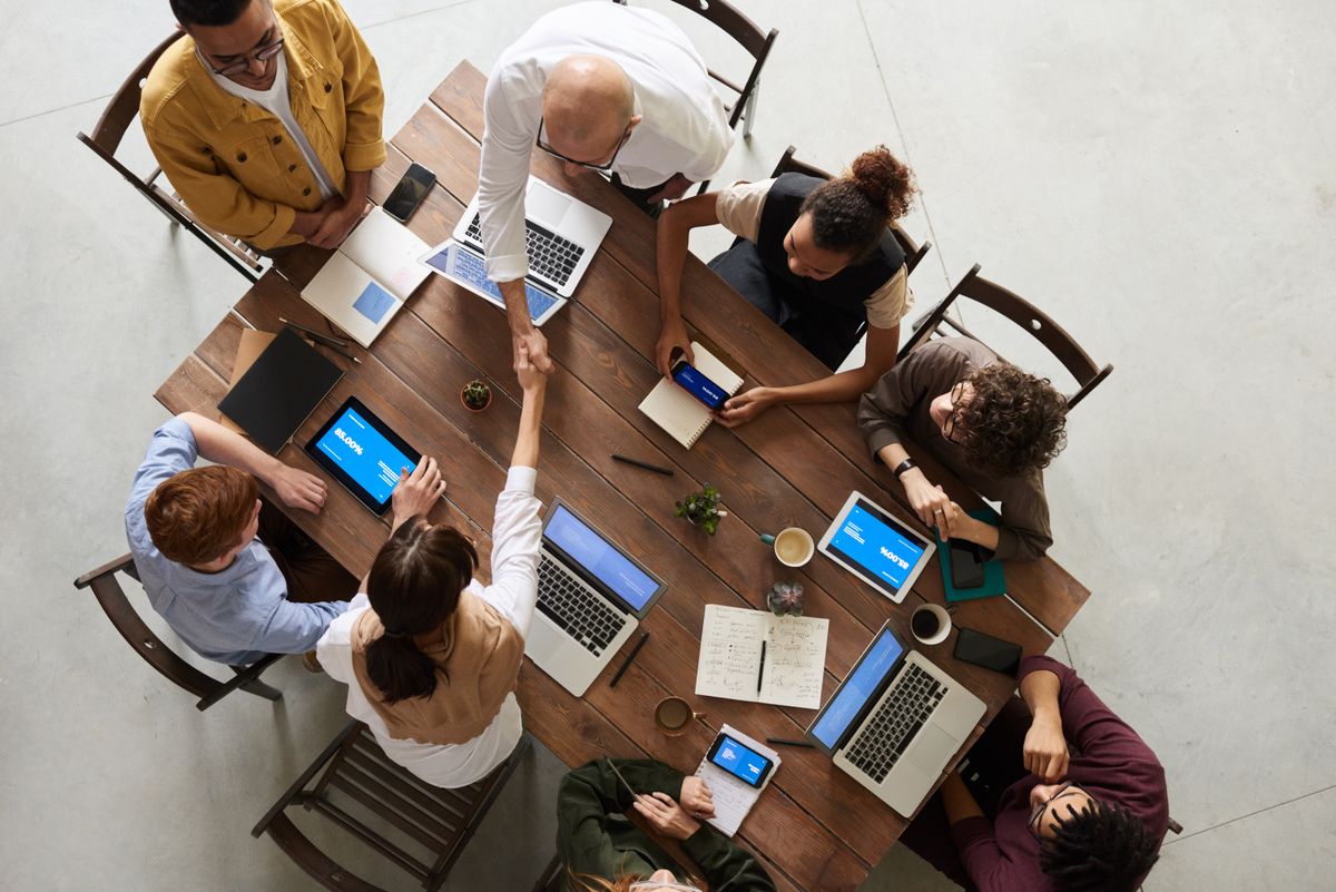 Team handoff discussion after an AI marketing programme
